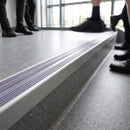 Aluminium Stair Nosing 63.5mm Tread Raked Back Single Channel in mill aluminium finish fitted on a step edge