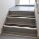 Brown insert 63mm x 32mm aluminium stair nosing with photoluminescent front strip fitted to grey vinyl steps