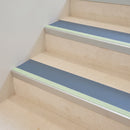 Dolphin Grey insert 63mm x 32mm aluminium stair nosing with photoluminescent front strip fitted to pale stone steps