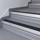 Black Olympic Grip insert in a cut to size 66x55mm aluminium stair nosing with 13mm Light Grey riser highlight, fitted to interior steps