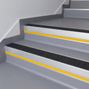 Black Olympic Grip insert in a 66x55mm square front aluminium stair nosing with 13mm Yellow riser highlight, fitted to interior steps