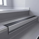 Black Smooth Textured insert in a cut to size 66x55mm aluminium stair nosing with 13mm Light Grey riser highlight, fitted to interior steps