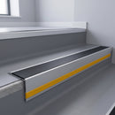 Black Smooth Textured insert in a 66x55mm square front aluminium stair nosing with 13mm Yellow riser highlight, fitted to interior steps