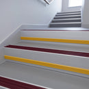 Claret Castellated insert in a 66x55mm square front aluminium stair nosing with 13mm Yellow riser highlight, fitted to interior steps