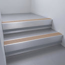 Fawn Castellated insert in a 66x55mm square front aluminium stair nosing with 13mm Light Grey riser highlight, fitted to interior steps