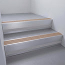 Fawn Castellated insert in a 66x55mm square front aluminium stair nosing with 13mm Polar Grey riser highlight, fitted to interior steps