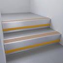 Fawn Castellated insert in a cut to size 66x55mm aluminium stair nosing with 13mm Yellow riser highlight, fitted to interior steps