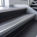Flint Castellated insert in a cut to size 66x55mm aluminium stair nosing with 13mm Light Grey riser highlight, fitted to interior steps