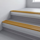Gold Castellated insert in a 66x55mm square front aluminium stair nosing with 13mm Polar Grey riser highlight, fitted to interior steps