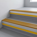 Gold Castellated insert in a 66x55mm square front aluminium stair nosing with 13mm Yellow riser highlight, fitted to interior steps
