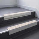 Ivory Castellated insert in a 66x55mm square front aluminium stair nosing with 13mm Polar Grey riser highlight, fitted to interior steps