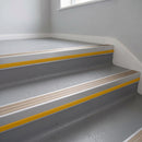 Light Bronze Aluminium insert in a cut to size 66x55mm aluminium stair nosing with 13mm Yellow riser highlight, fitted to interior steps