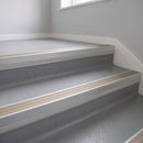 Light Bronze Aluminium insert in a 66x55mm square front aluminium stair nosing with 13mm Polar Grey riser highlight, fitted to interior steps