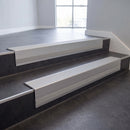 Light Grey Castellated insert in a 66x55mm square front aluminium stair nosing with 13mm Polar Grey riser highlight, fitted to interior steps
