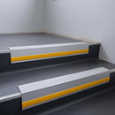 Light Grey Smooth Textured insert in a cut to size 66x55mm aluminium stair nosing with 13mm Yellow riser highlight, fitted to interior steps