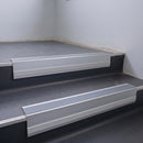 Light Grey Smooth Textured insert in a 66x55mm square front aluminium stair nosing with 13mm Polar Grey riser highlight, fitted to interior steps
