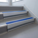 Mid Blue Castellated insert in a cut to size 66x55mm aluminium stair nosing with 13mm Light Grey riser highlight, fitted to interior steps