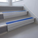Mid Blue Castellated insert in a cut to size 66x55mm aluminium stair nosing with 13mm Polar Grey riser highlight, fitted to interior steps