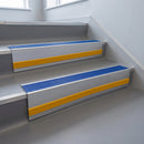Mid Blue Castellated insert in a cut to size 66x55mm aluminium stair nosing with 13mm Yellow riser highlight, fitted to interior steps