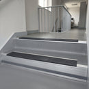 Nimbus Castellated insert in a cut to size 66x55mm aluminium stair nosing with 13mm Light Grey riser highlight, fitted to interior steps