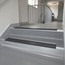 Nimbus Castellated insert in a cut to size 66x55mm aluminium stair nosing with 13mm Polar Grey riser highlight, fitted to interior steps