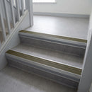 Olive Castellated insert in a cut to size 66x55mm aluminium stair nosing with 13mm Light Grey riser highlight, fitted to interior steps
