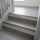 Olive Castellated insert in a cut to size 66x55mm aluminium stair nosing with 13mm Polar Grey riser highlight, fitted to interior steps
