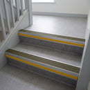 Olive Castellated insert in a cut to size 66x55mm aluminium stair nosing with 13mm Yellow riser highlight, fitted to interior steps