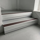Peat Castellated insert in a 66x55mm square front aluminium stair nosing with 13mm Polar Grey riser highlight, fitted to interior steps