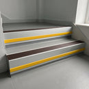 Peat Castellated insert in a 66x55mm square front aluminium stair nosing with 13mm Yellow riser highlight, fitted to interior steps