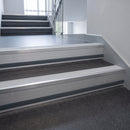 Polar Grey Castellated insert in a 66x55mm square front aluminium stair nosing with 13mm Light Grey riser highlight, fitted to interior steps