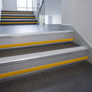 Polar Grey Castellated insert in a 66x55mm square front aluminium stair nosing with 13mm Yellow riser highlight, fitted to interior steps