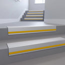 Polar Grey Smooth Textured insert in a cut to size 66x55mm aluminium stair nosing with 13mm Yellow riser highlight, fitted to interior steps