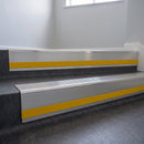 Polished Aluminium insert in a cut to size 66x55mm aluminium stair nosing with 13mm Yellow riser highlight, fitted to interior steps