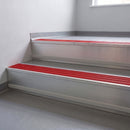 Poppy Castellated insert in a cut to size 66x55mm aluminium stair nosing with 13mm Polar Grey riser highlight, fitted to interior steps