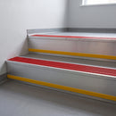 Poppy Castellated insert in a cut to size 66x55mm aluminium stair nosing with 13mm Yellow riser highlight, fitted to interior steps