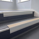 Porth Stone Castellated insert in a cut to size 66x55mm aluminium stair nosing with 13mm Polar Grey riser highlight, fitted to interior steps