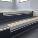 Porth Stone Castellated insert in a cut to size 66x55mm aluminium stair nosing with 13mm Light Grey riser highlight, fitted to interior steps
