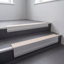 Porth Stone Smooth Textured insert in a 66x55mm square front aluminium stair nosing with 13mm Polar Grey riser highlight, fitted to interior steps
