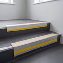 Porth Stone Smooth Textured insert in a cut to size 66x55mm aluminium stair nosing with 13mm Yellow riser highlight, fitted to interior steps