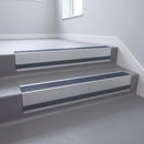 Regency Castellated insert in a 66x55mm square front aluminium stair nosing with 13mm Light Grey riser highlight, fitted to interior steps