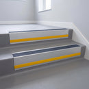 Regency Castellated insert in a cut to size 66x55mm aluminium stair nosing with 13mm Yellow riser highlight, fitted to interior steps