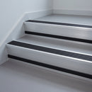 Black Anodised Aluminium insert in a cut to size 66x55mm aluminium stair nosing with 13mm black riser highlight, fitted to interior steps
