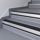 Black Olympic Grip insert in a 66x55mm square front aluminium stair nosing with 13mm black riser highlight, fitted to interior steps