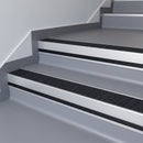 Black Olympic Grip insert in a cut to size 66x55mm aluminium stair nosing with 13mm black riser highlight, fitted to interior steps