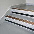 Bronze Aluminium insert in a 66x55mm square front aluminium stair nosing with 13mm black riser highlight, fitted to interior steps