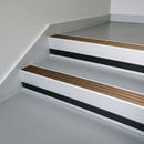 Bronze Aluminium insert in a cut to size 66x55mm aluminium stair nosing with 13mm black riser highlight, fitted to interior steps