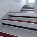Claret Castellated insert in a 66x55mm square front aluminium stair nosing with 13mm black riser highlight, fitted to interior steps