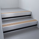 Fawn Castellated insert in a 66x55mm square front aluminium stair nosing with 13mm black riser highlight, fitted to interior steps