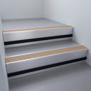 Fawn Castellated insert in a cut to size 66x55mm aluminium stair nosing with 13mm black riser highlight, fitted to interior steps